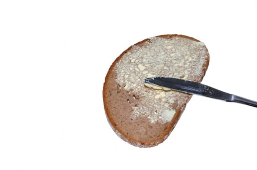 Bread with butter and knife against a white background