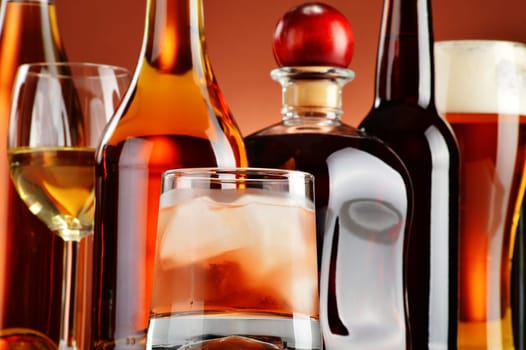 Bottles and glasses of assorted alcoholic beverages.