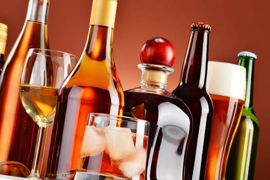 Bottles and glasses of assorted alcoholic beverages.