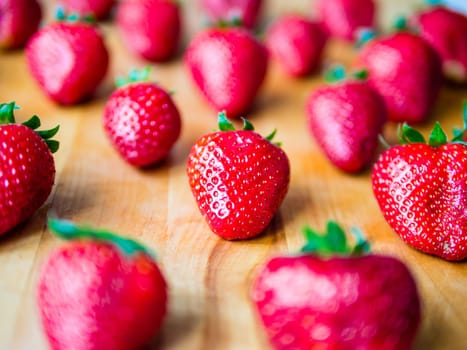 Arranged fresh strawberries on a wooden board