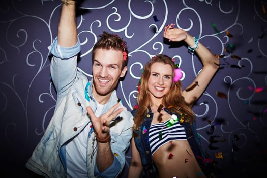 Ecstatic young couple having fun in night club