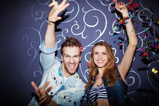 Amorous young couple dancing in night club