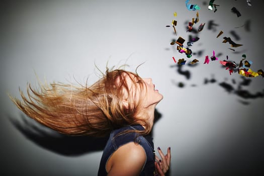 Energetic female dancer with blond hair in nightclub