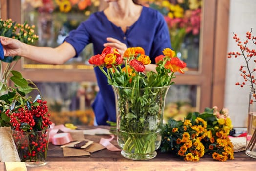 Fresh flowers at florist workplace in design studio