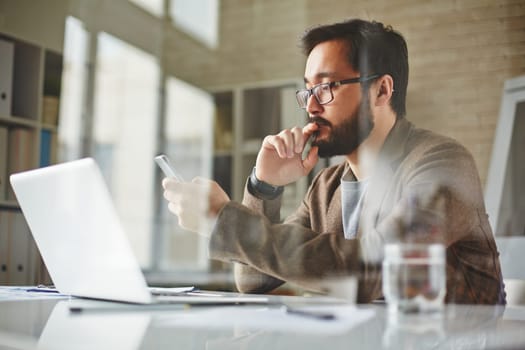 Modern office worker writing sms