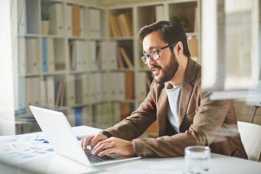 Young businessman typing in office