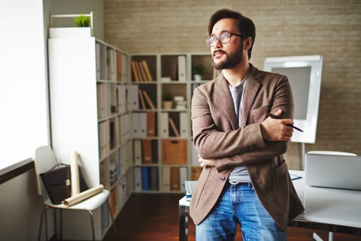 Asian businessman having short break in office