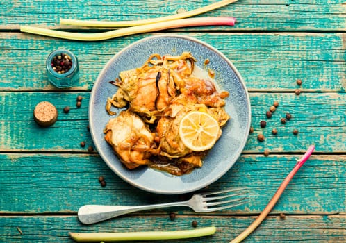 Delicious baked chicken meat with rhubarb stalks. Chicken breast with rhubarb sauce.
