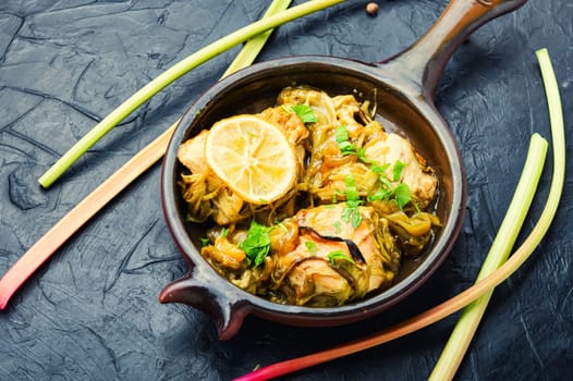 Delicious baked chicken meat with rhubarb stalks. Chicken breast with rhubarb sauce.