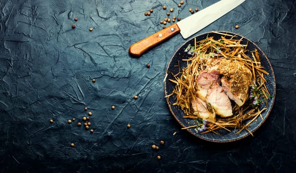 Meat braised in fresh hay.Roasted pork loin in hays.Roasted pork shoulder