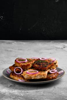 Pork fillet mignon roasted on cast iron pan, served with red onion and dill