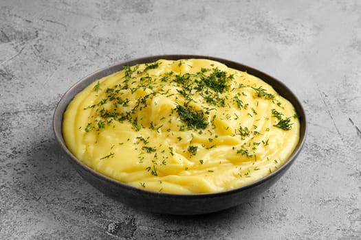 Ceramic plate with mashed potato on abstract concrete background