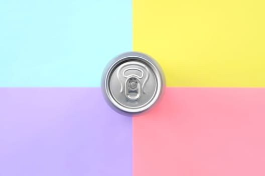 Tin aluminum silver beer can on a pastel background. Minimal flat lay top view. Living coral, violet, blue and yellow colors