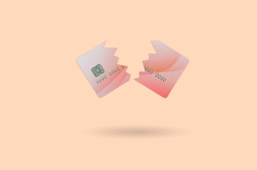 Cut and broken red credit card floating in the pastel orange space. The concept of ban to use banking services. Credit card expire end soon