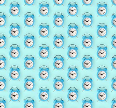 Flat lay retro beautiful new alarm clock on blue color background. Minimal pattern. Top view. Wasting time concept