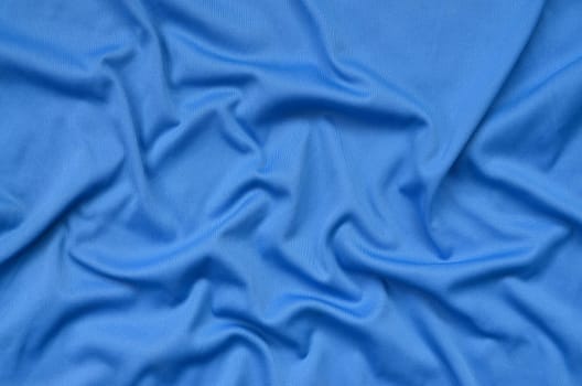Detailed polyester blue fabric texture with many long folds