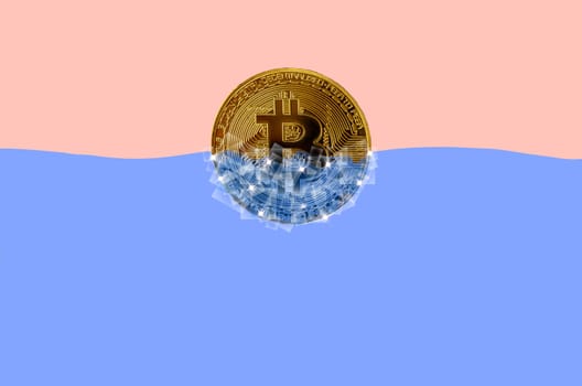 Frozen golden bitcoin in blocks of ice in blue water. The concept of freezing of a cryptocurrency grow or wallet for security purposes.