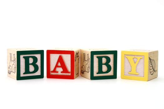 word baby formed by alphabet wood blocks on a white surface
