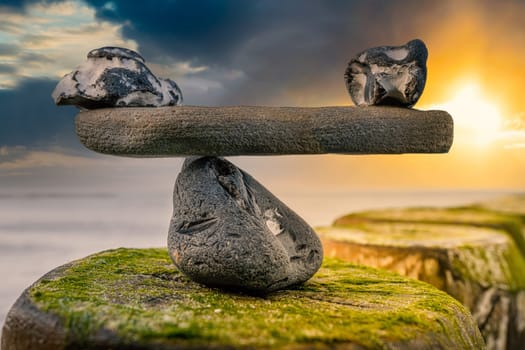 in balance - natural scales of stones by the sea - symbol photo