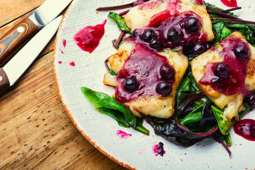 Delicious baked fish with berry sauce. Stewed pangasius with blueberries