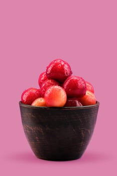Fresh red cherries in clay bowl
