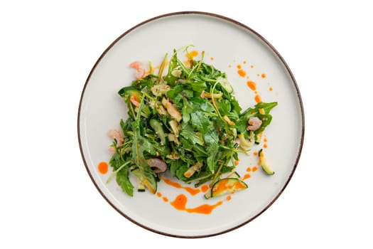 Salad with shrimps, arugula, cucumber and spicy sauce isolated on white background