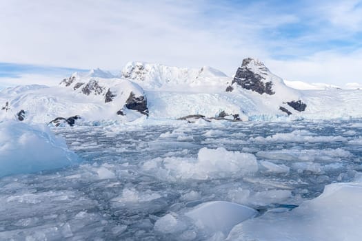 Antarctic iceberg landscape in Cierva Cove - a deep inlet on the west side of the Antarctic Peninsula, surrounded by rugged mountains and dramatic glacier fronts.