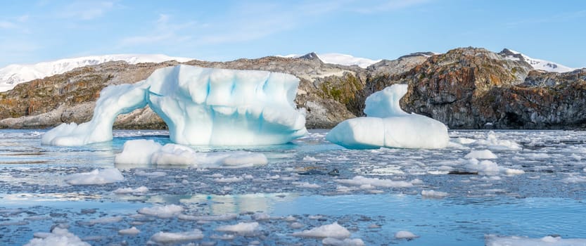 Antarctic iceberg landscape in Cierva Cove - a deep inlet on the west side of the Antarctic Peninsula, surrounded by rugged mountains and dramatic glacier fronts.