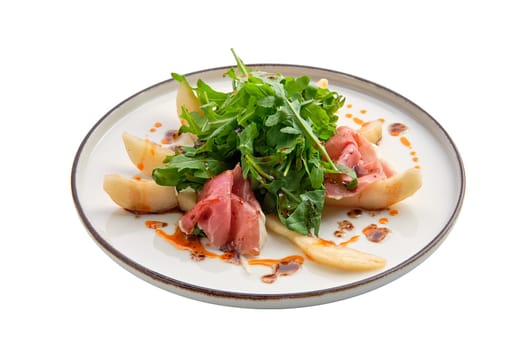 Salad with jamon, pear and arugula isolated on white background
