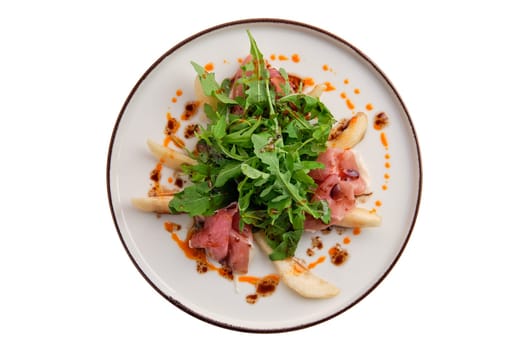 Salad with jamon, pear and arugula isolated on white background