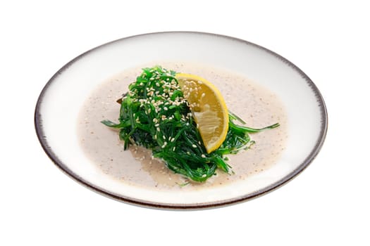Plate with chuka salad, nut sauce and sesame isolated on white background