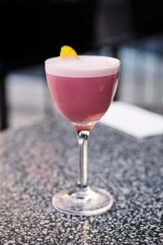 Cherry brandy cocktail on the table on outdoor terrace (Photo with shallow depth of field)