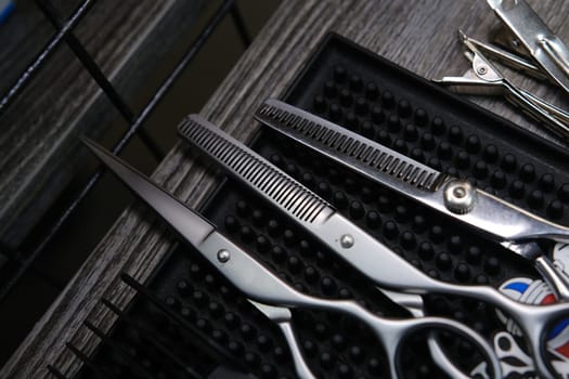 Vintage barber shop tools on old wooden background and rubber mat.