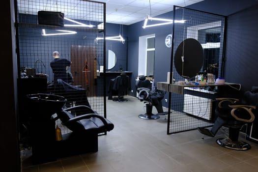Stylish Vintage Barber Chairs In Black And Grey Interior. Barbershop Theme, Barbershop and barber working with client.
