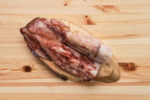 Frozen fresh octopus or squids raw on wooden board