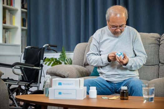 Asian old man buy herbal self cure Rx pill online from pharmacy, worried senior man with medicine pills he read on see how to take pills before taking, home isolation, Medical service concept