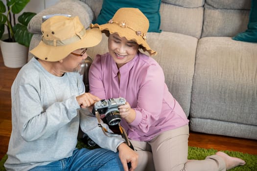 Travel and tourism. Happy mature retired couple photography weekend holiday, Asian couple old senior marry retired couple smiling taking photo by camera during luggage suitcase arranging for travel