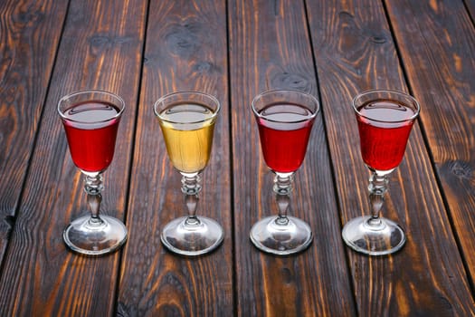 Vodka infused with berries on wooden background (photo with shallow depth of field)