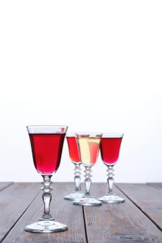 Vodka infused with berries on wooden background (photo with shallow depth of field)