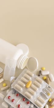 Mix of pills and capsules in a aluminum and plastic blisters with some missing pills already used on light beige close up, copy space. Preventive medicine and healthcare, dietary supplements