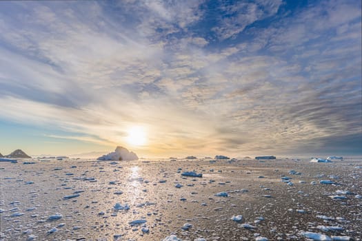dramatic, colourful sunset / evening atmosphere in Cierva Cove - a deep inlet on the west side of the Antarctic Peninsula, surrounded by Cierva Bay in San Martín Land - Antarctica photographed from an expedition ship