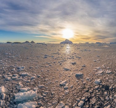 dramatic, colourful sunset / evening atmosphere in Cierva Cove - a deep inlet on the west side of the Antarctic Peninsula, surrounded by Cierva Bay in San Martín Land - Antarctica photographed from an expedition ship