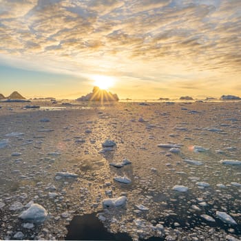 dramatic, colourful sunset / evening atmosphere in Cierva Cove - a deep inlet on the west side of the Antarctic Peninsula, surrounded by Cierva Bay in San Martín Land - Antarctica photographed from an expedition ship