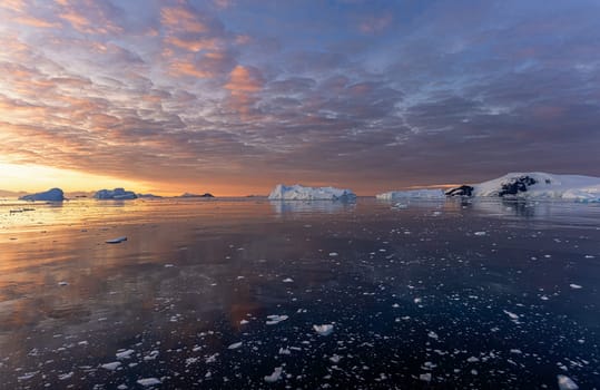 dramatic, colourful sunset / evening atmosphere in Cierva Cove - a deep inlet on the west side of the Antarctic Peninsula, surrounded by Cierva Bay in San Martín Land - Antarctica photographed from an expedition ship