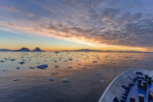 dramatic, colourful sunset / evening atmosphere in Cierva Cove - a deep inlet on the west side of the Antarctic Peninsula, surrounded by Cierva Bay in San Martín Land - Antarctica photographed from an expedition ship