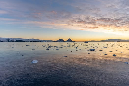 dramatic, colourful sunset / evening atmosphere in Cierva Cove - a deep inlet on the west side of the Antarctic Peninsula, surrounded by Cierva Bay in San Martín Land - Antarctica photographed from an expedition ship