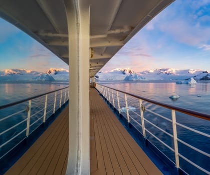 Cabin window reflection on a cruise ship at a dramatic sunset in wintry Cierva Cove - a deep inlet on the west side of the Antarctic Peninsula, surrounded by Cierva Bay in San Martín Land – Antarctica