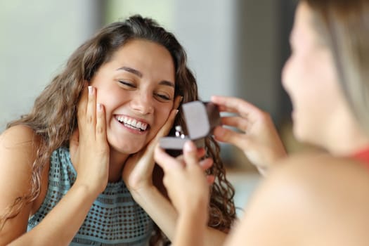 Happy lesbian woman in a marriage proposal accepting engagement