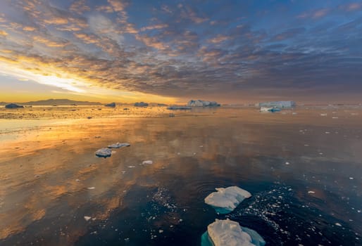 dramatic, colourful sunset / evening atmosphere in Cierva Cove - a deep inlet on the west side of the Antarctic Peninsula, surrounded by Cierva Bay in San Martín Land - Antarctica photographed from an expedition ship