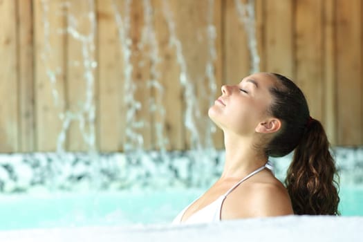 Profile of a serious woman breathing and bathing in spa pool